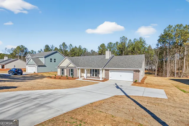 a view of a house next to a road and yard