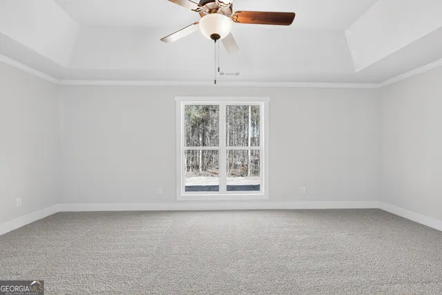 an empty room with a window and a fan