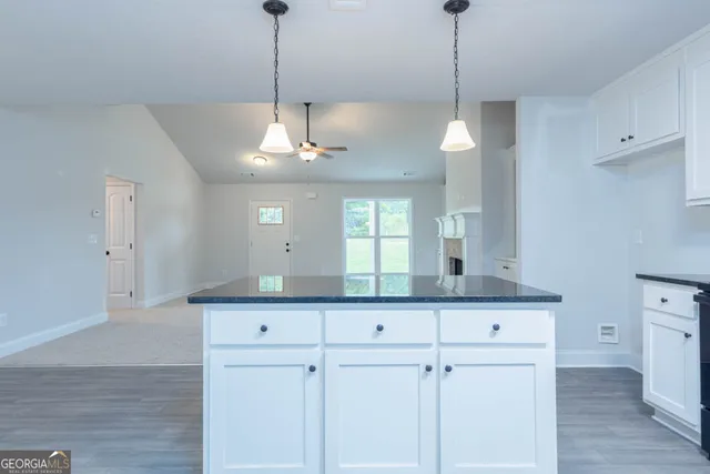 a kitchen with kitchen island white cabinets and white appliances