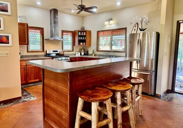 a kitchen with stainless steel appliances stove a sink and dishwasher a refrigerator with wooden floor