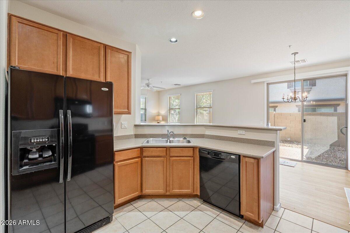 1255 South Rialto, Unit 106 Mesa, AZ 85209 - Photo 12 of 32 a kitchen with a sink a refrigerator and cabinets