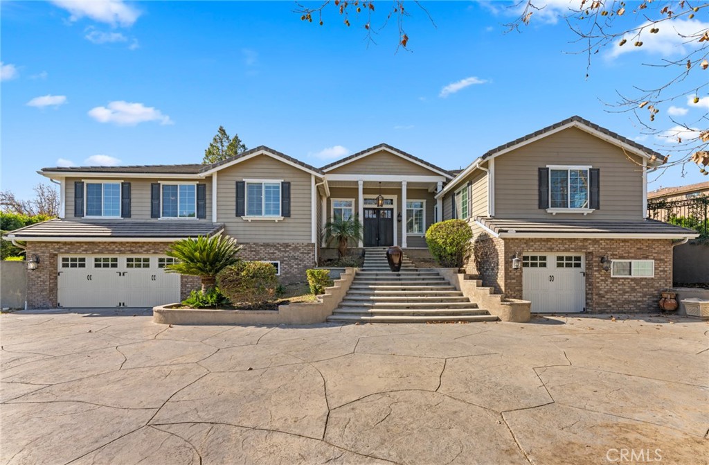 a front view of a house with a garden