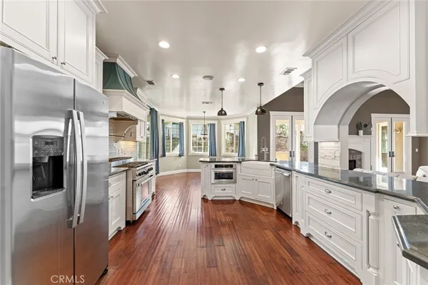 a bathroom with a granite countertop sink toilet mirror and shower