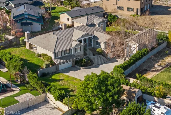 an aerial view of multiple houses with yard