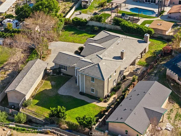 an aerial view of a house with a yard
