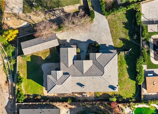 an aerial view of multiple houses with a yard