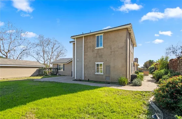 a large kitchen with stainless steel appliances kitchen island granite countertop a large counter top a stove a chimney a sink and cabinets