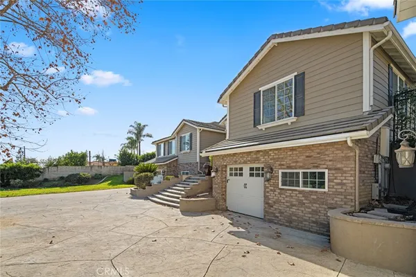 a large kitchen with stainless steel appliances kitchen island granite countertop a large counter top a stove a chimney a sink and cabinets