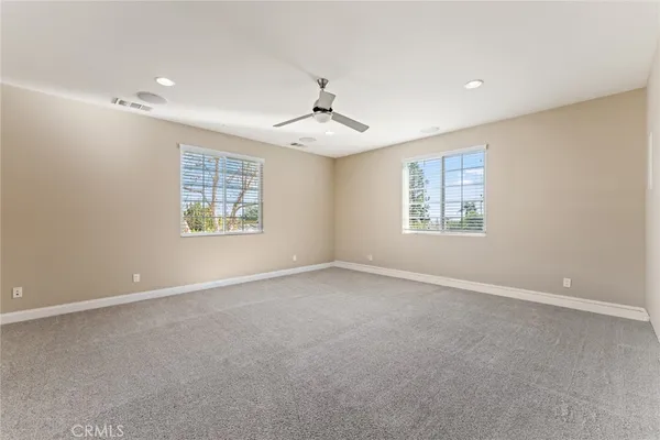 a room with a chandelier and wooden floor