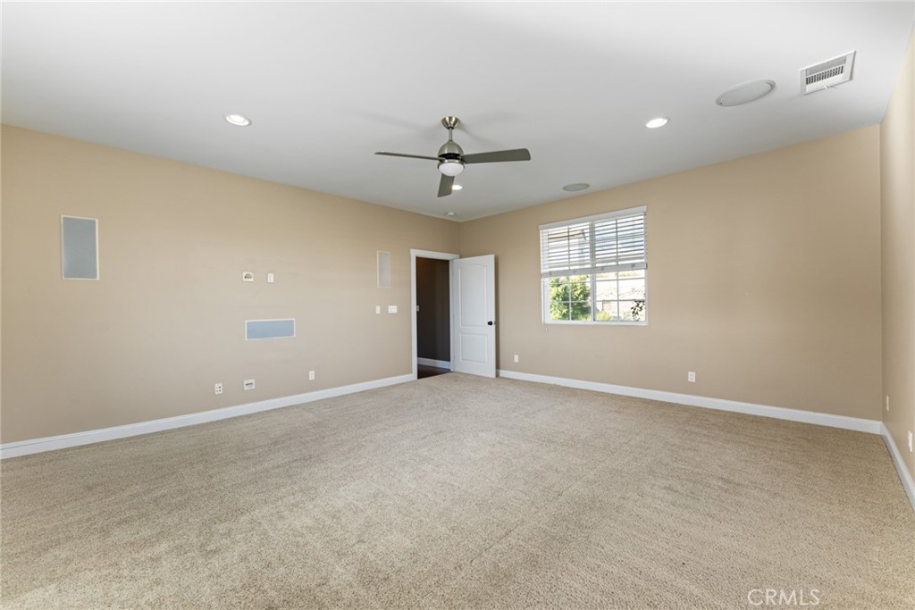 5836 Buckthorn Avenue Rancho Cucamonga, CA 91737 - Photo 44 of 63 an empty room with a window and a ceiling fan