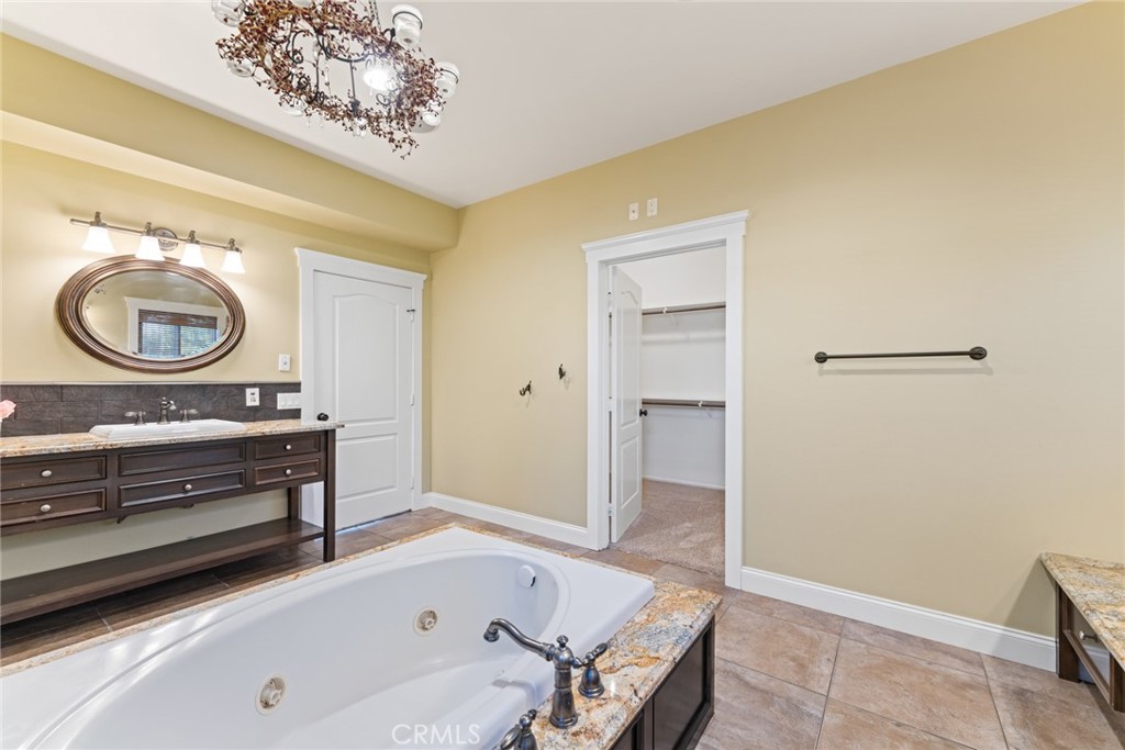 5836 Buckthorn Avenue Rancho Cucamonga, CA 91737 - Photo 56 of 63 a bathroom with a tub and a sink