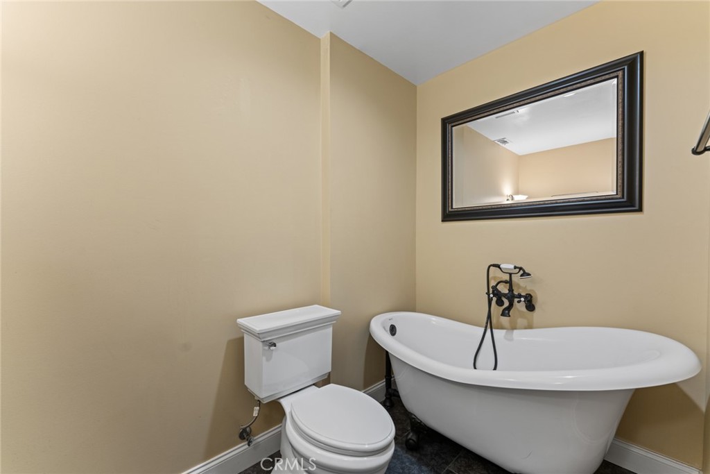 5836 Buckthorn Avenue Rancho Cucamonga, CA 91737 - Photo 58 of 63 a white toilet sitting next to a bathroom sink