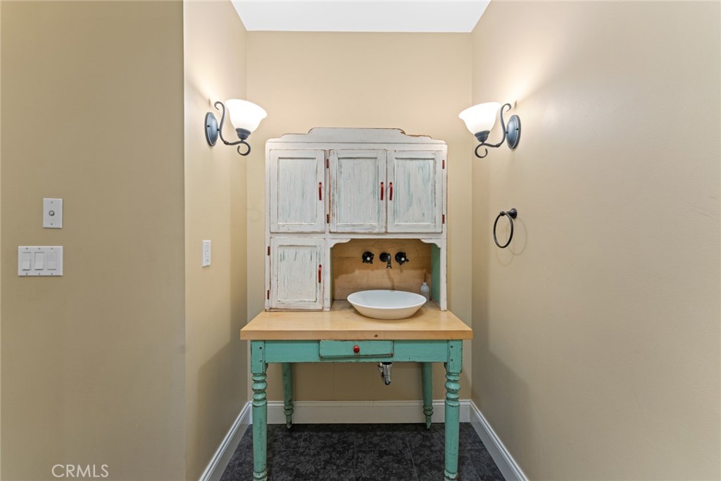 5836 Buckthorn Avenue Rancho Cucamonga, CA 91737 - Photo 59 of 63 a bathroom with a sink and a mirror