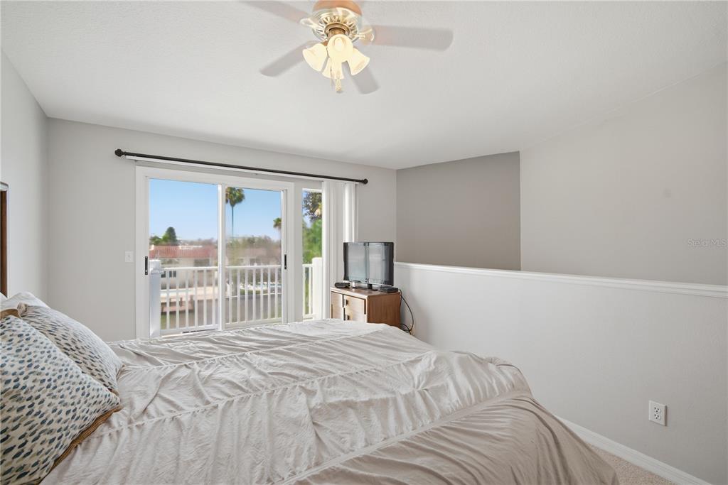 643 Garland Circle Indian Rocks Beach, FL 33785 - Photo 36 of 81 a bedroom with a large bed and a large window