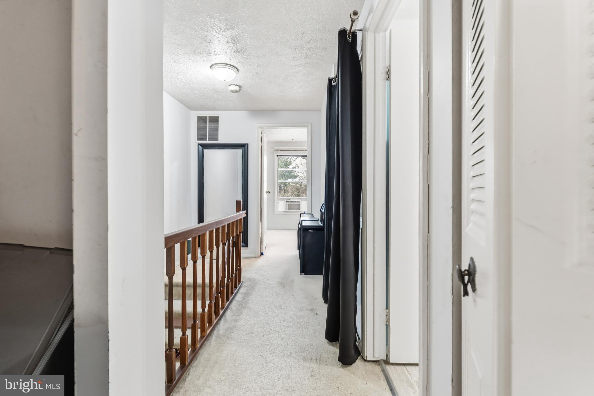 19218 Misty Meadow Terrace Germantown, MD 20874 - Photo 12 of 17 a view of a hallway with wooden floor and staircase
