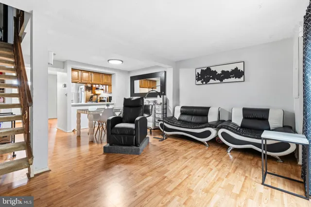 a living room with furniture a rug and a flat screen tv