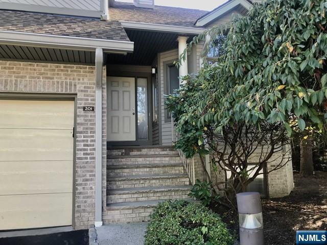 201 Beech Court Norwood, NJ 07648 - Photo 2 of 12 a front view of a house with a garden