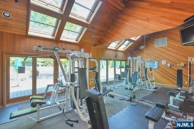 a room with gym equipment and large windows