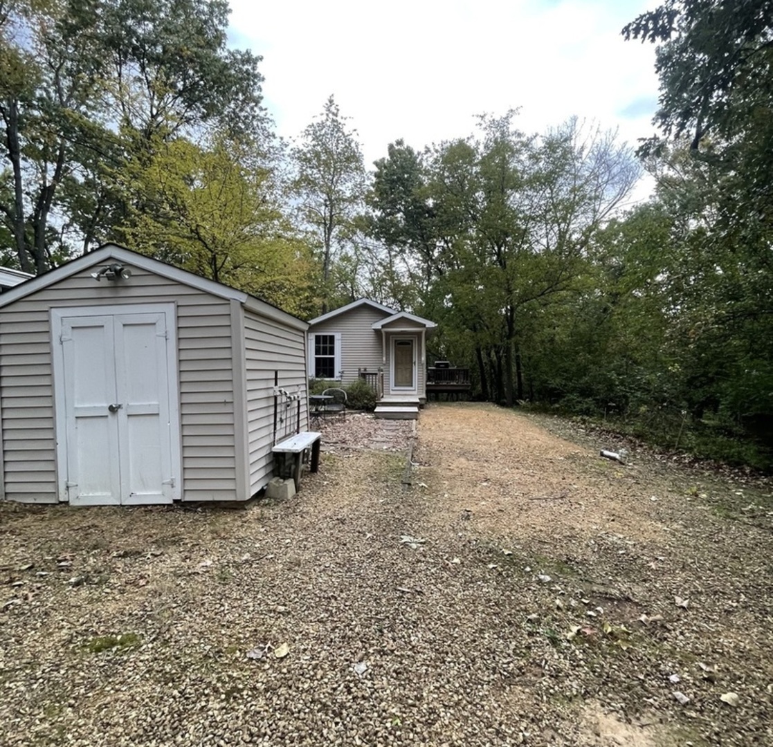 27-58 Woodhaven Lakes Sublette, IL 61367 - Photo 1 of 12 a front view of house with yard and trees