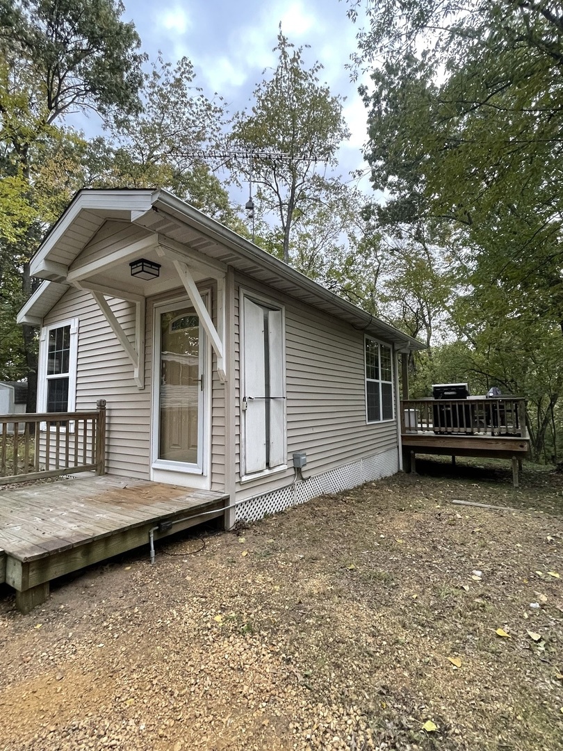 27-58 Woodhaven Lakes Sublette, IL 61367 - Photo 12 of 12 a house with trees in the background