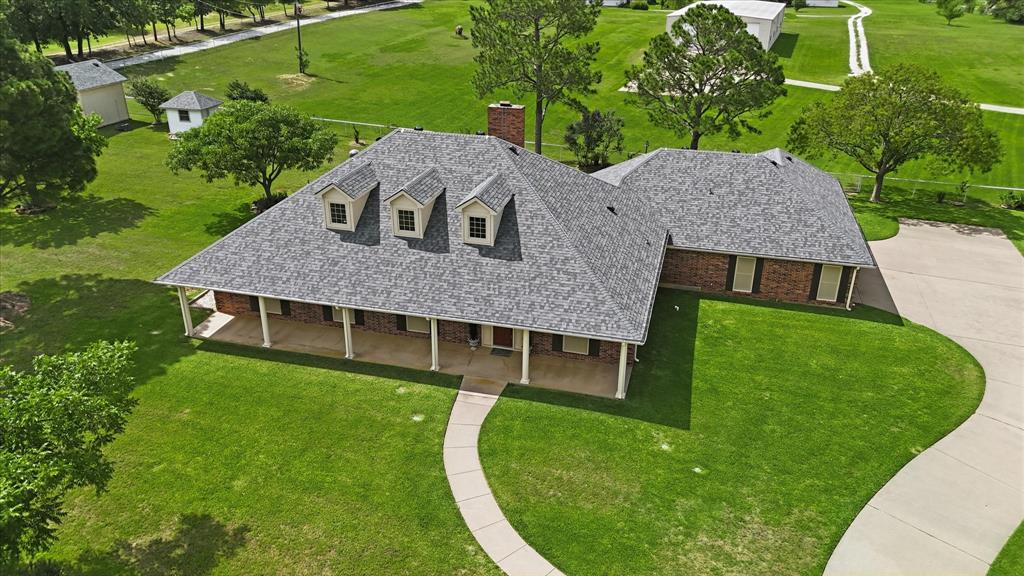6955 Hawk Road Flower Mound, TX 75022 - Photo 37 of 40 Spacious ranch-style residence featuring a brick exterior and a gray shingled roof with three dormer windows