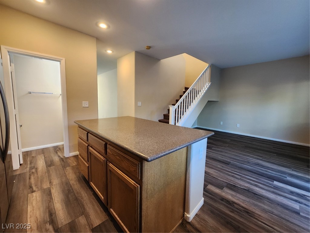 9409 Crimson Sky Street Las Vegas, NV 89178 - Photo 45 of 46 Kitchen with a kitchen island, dark wood-style floors, recessed lighting, stainless steel refrigerator, and open floor plan