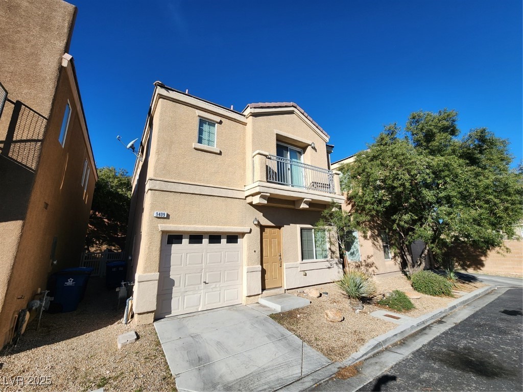 9409 Crimson Sky Street Las Vegas, NV 89178 - Photo 2 of 46 View of front of house with a balcony, stucco siding, a garage, and concrete driveway