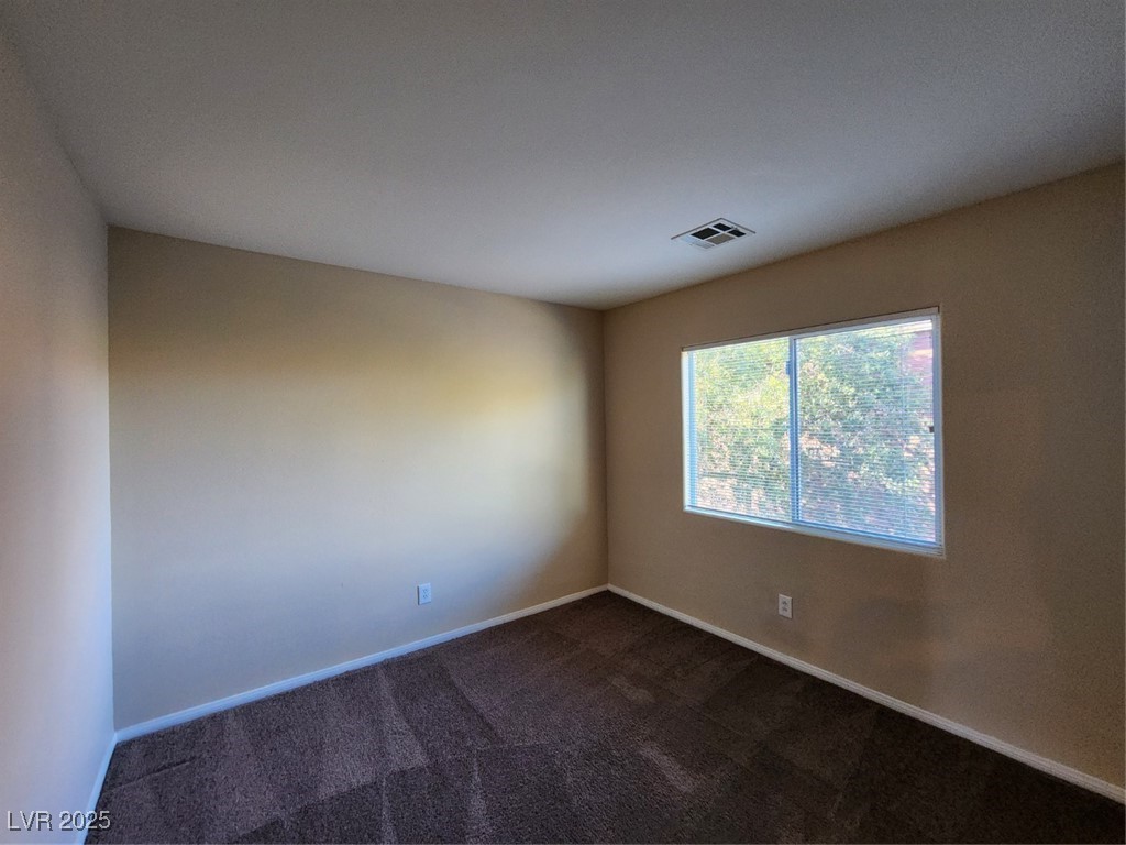 9409 Crimson Sky Street Las Vegas, NV 89178 - Photo 20 of 46 Unfurnished room with dark carpet and baseboards