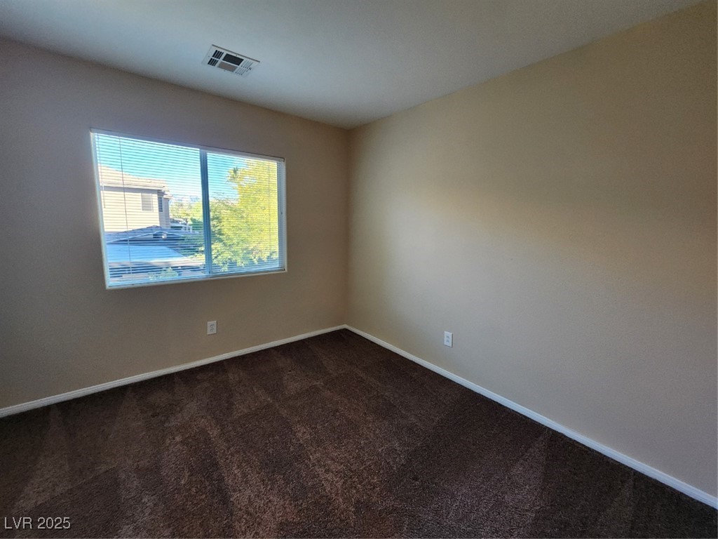 9409 Crimson Sky Street Las Vegas, NV 89178 - Photo 24 of 46 Spare room with dark colored carpet and baseboards