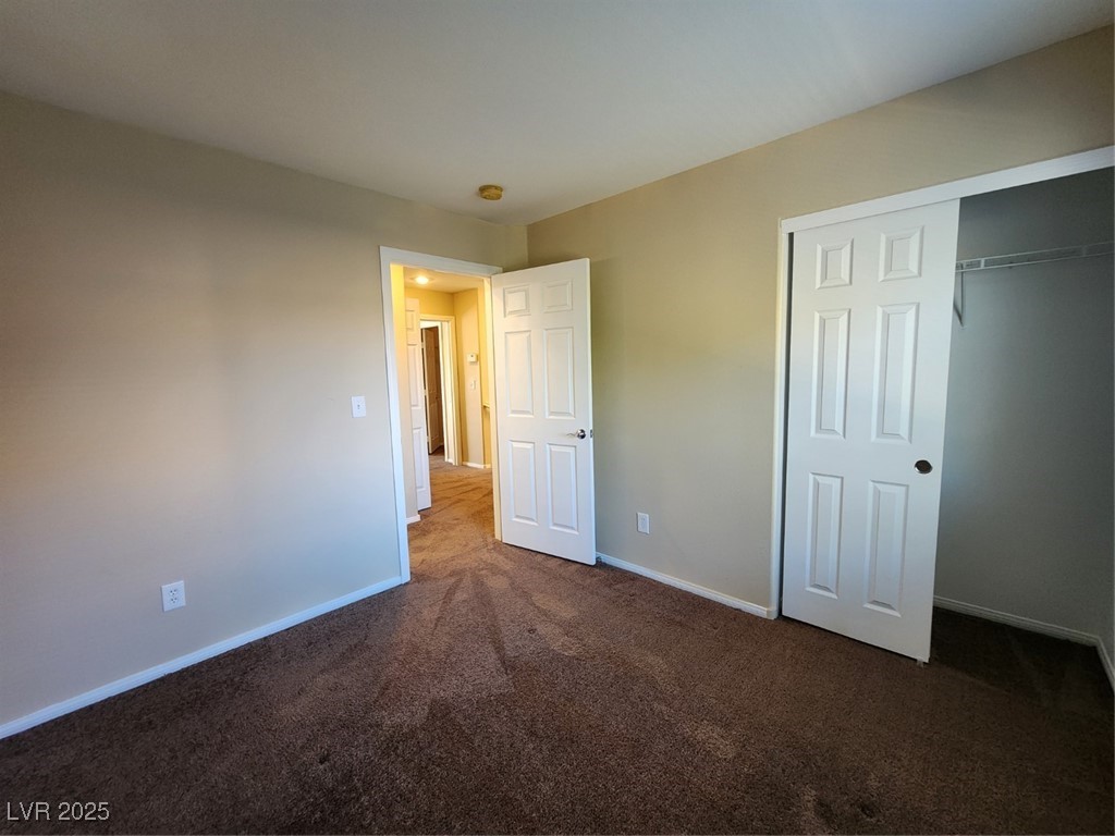9409 Crimson Sky Street Las Vegas, NV 89178 - Photo 26 of 46 Unfurnished bedroom with a closet and dark carpet
