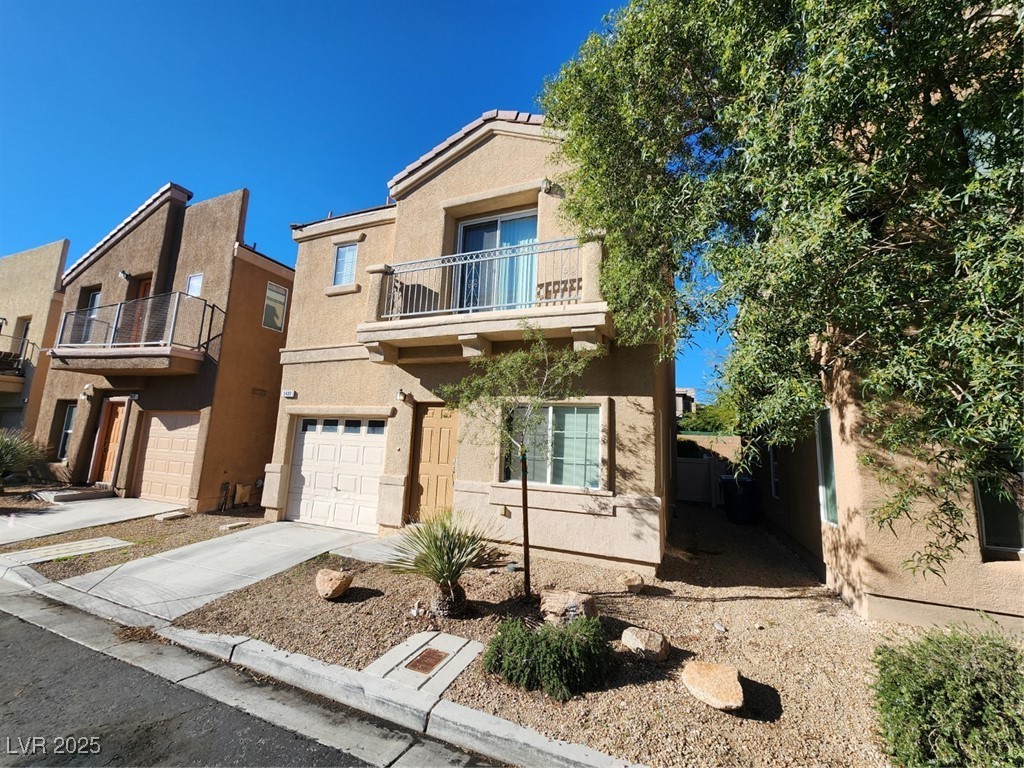 9409 Crimson Sky Street Las Vegas, NV 89178 - Photo 3 of 46 View of front of property featuring a balcony, concrete driveway, stucco siding, and a garage