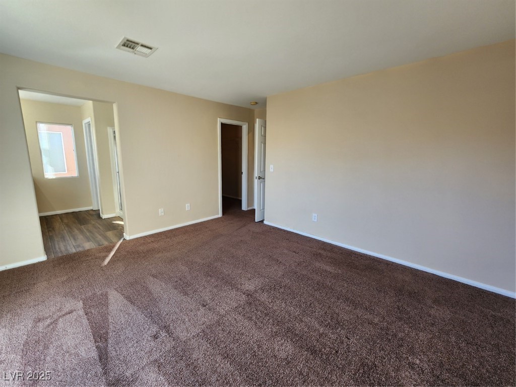 9409 Crimson Sky Street Las Vegas, NV 89178 - Photo 31 of 46 Spare room featuring dark colored carpet and baseboards