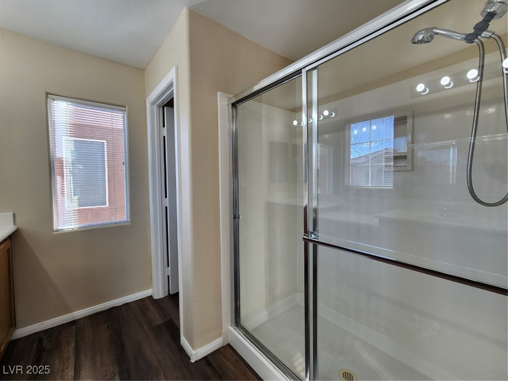 9409 Crimson Sky Street Las Vegas, NV 89178 - Photo 35 of 46 Bathroom with a stall shower, vanity, and dark wood-type flooring