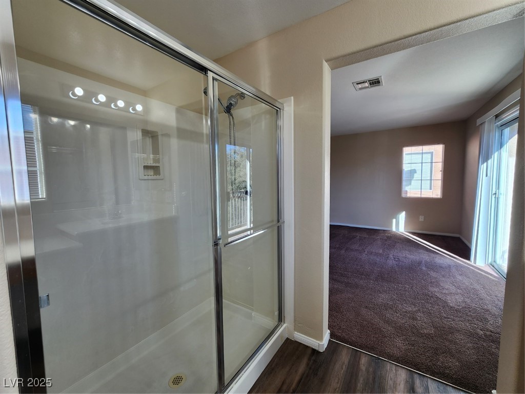 9409 Crimson Sky Street Las Vegas, NV 89178 - Photo 36 of 46 Full bath with a stall shower, dark carpet, and dark wood-style floors