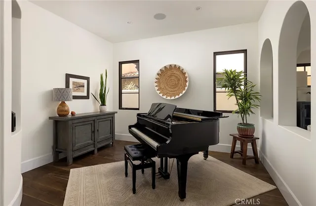 a living room with furniture and a piano