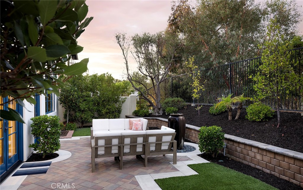 35209 Del Rey Dana Point, CA 92624 - Photo 16 of 44 a view of a patio with table and chairs potted plants and large tree