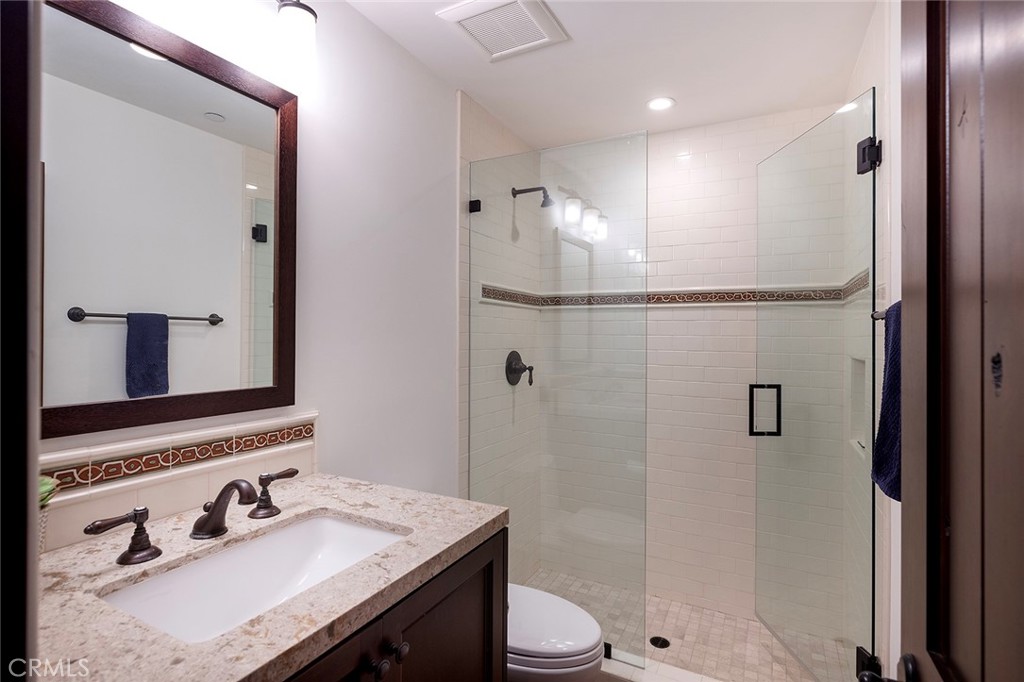 35209 Del Rey Dana Point, CA 92624 - Photo 37 of 44 a bathroom with a sink toilet a mirror and shower