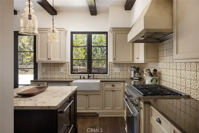 a kitchen with a sink stove and cabinets