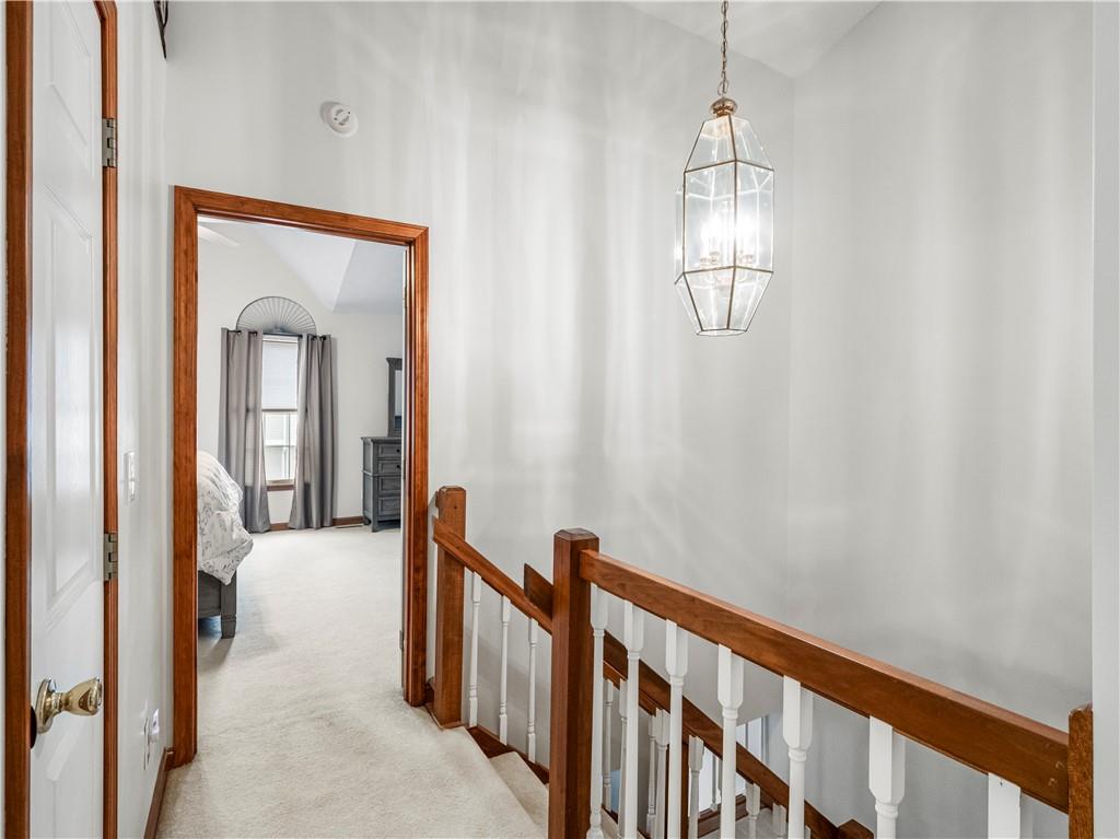 317 Brohios Drive Monaca, PA 15061 - Photo 13 of 27 a view of a hallway with wooden floor and chandelier