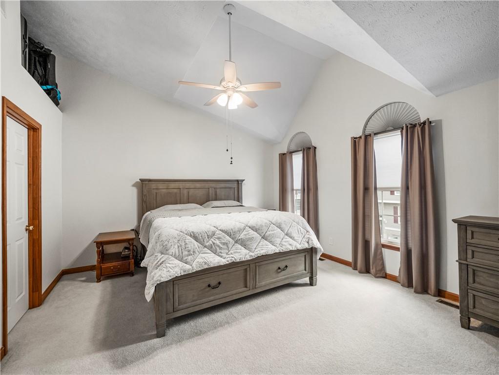 317 Brohios Drive Monaca, PA 15061 - Photo 14 of 27 a spacious bedroom with a bed and a chandelier