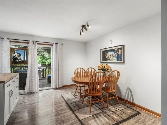a dining room with furniture a window and wooden floor