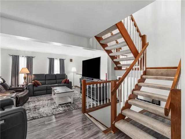 a living room with furniture or stairs and a wooden floor