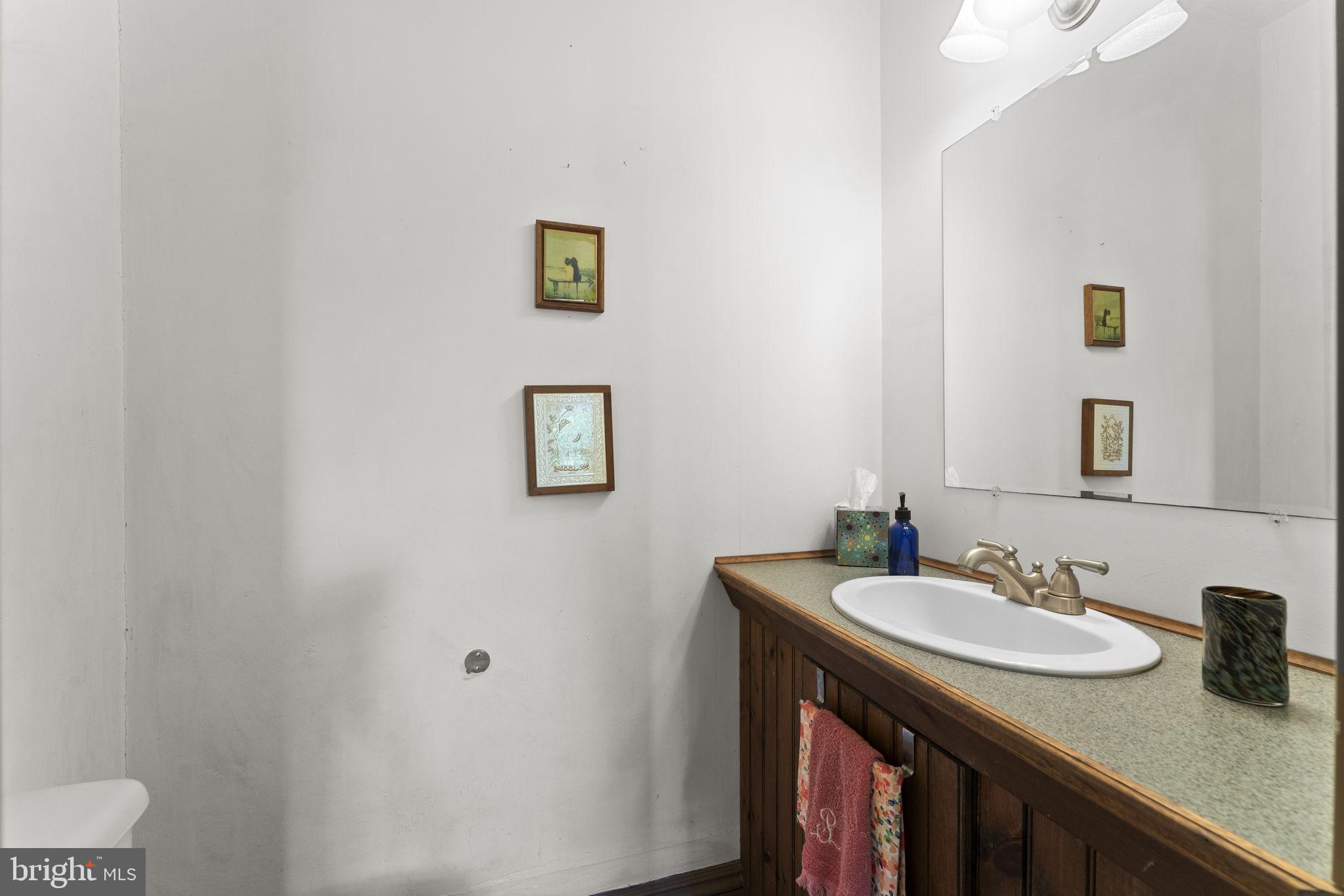 9039 Easton Road Ottsville, PA 18942 - Photo 15 of 61 a bathroom with a granite countertop sink and a mirror