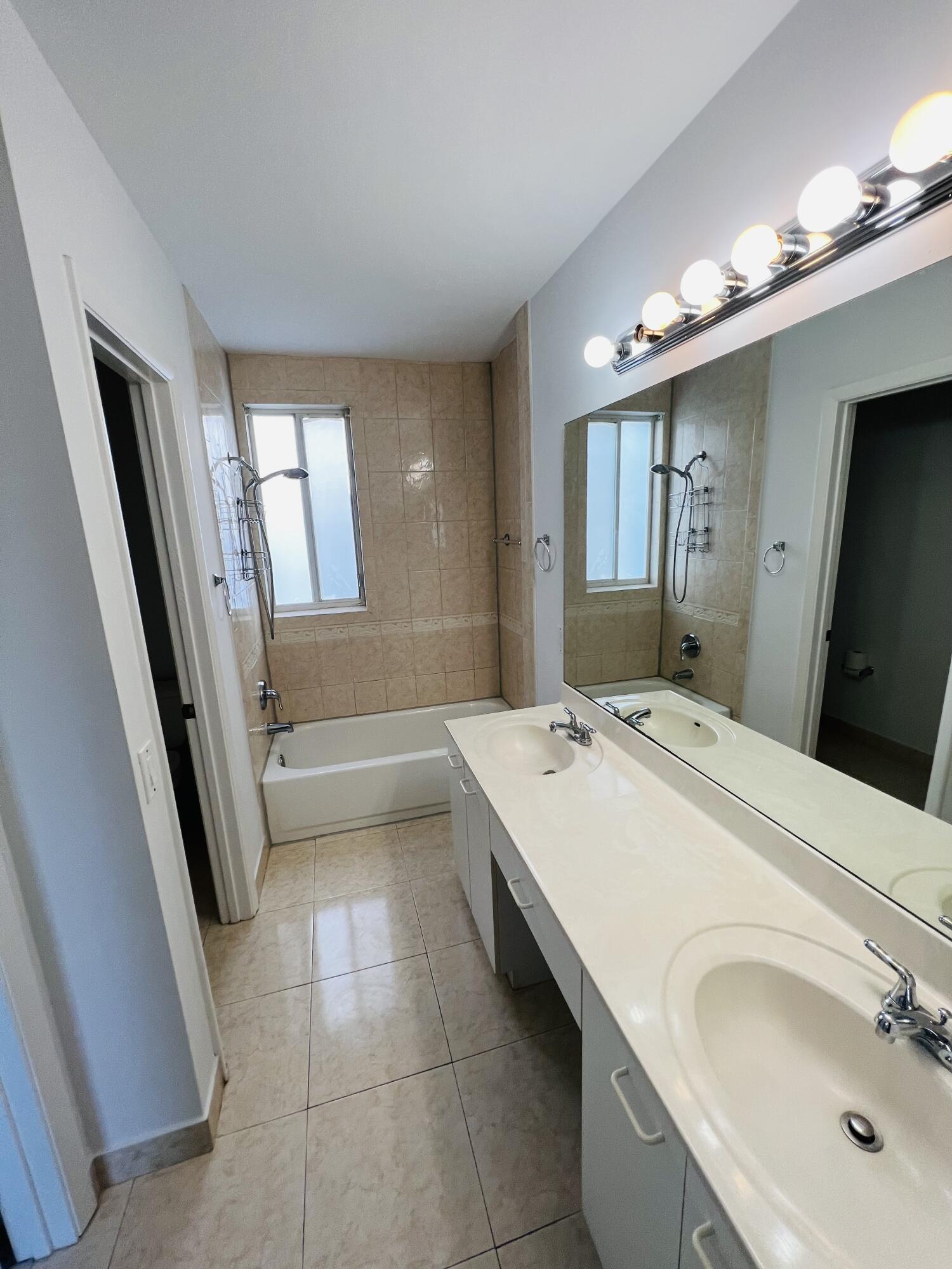 439 Talavera Road Weston, FL 33326 - Photo 12 of 17 a bathroom with a tub sink and mirror
