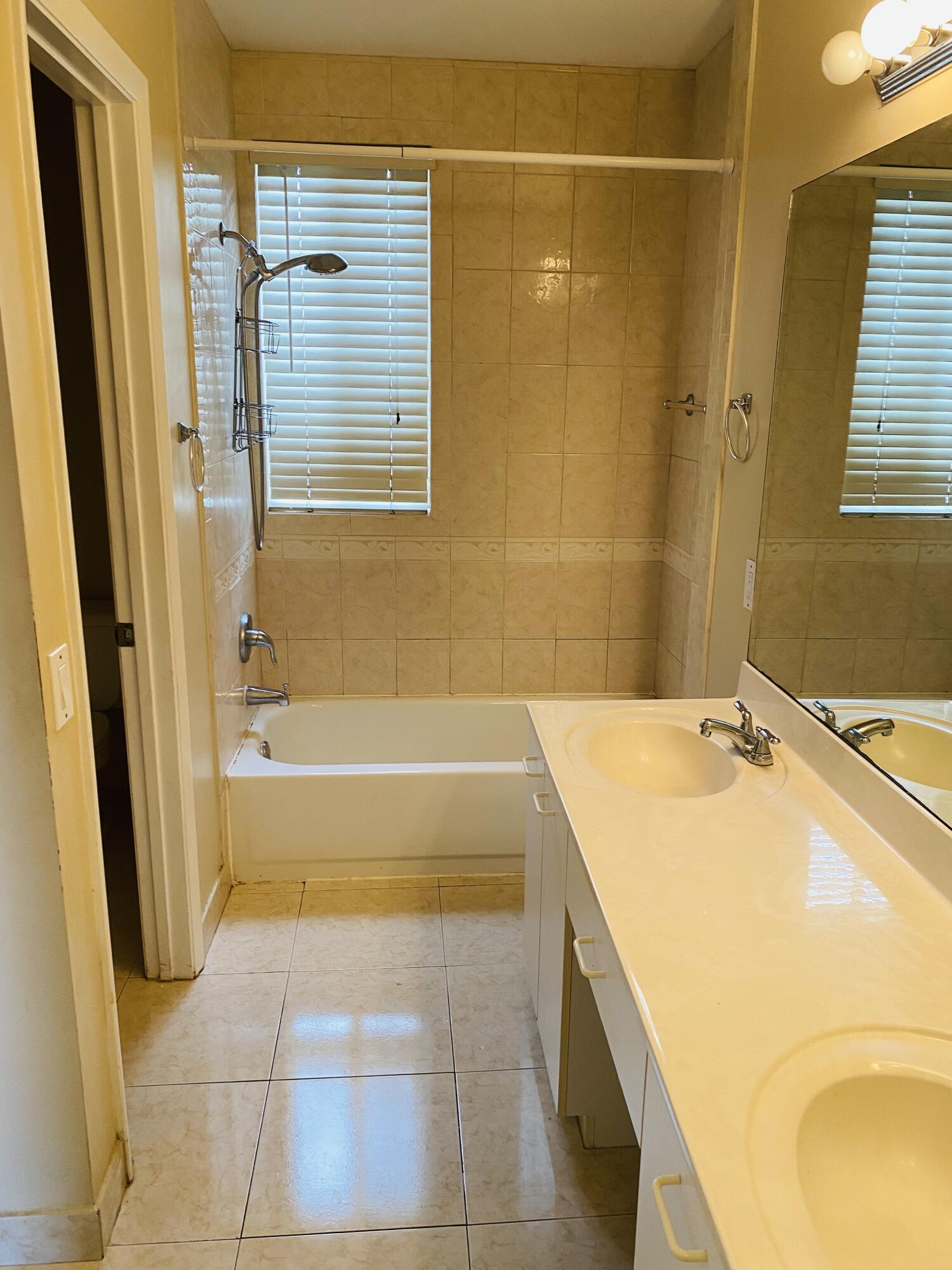 439 Talavera Road Weston, FL 33326 - Photo 14 of 17 a bathroom with a tub sink and a mirror