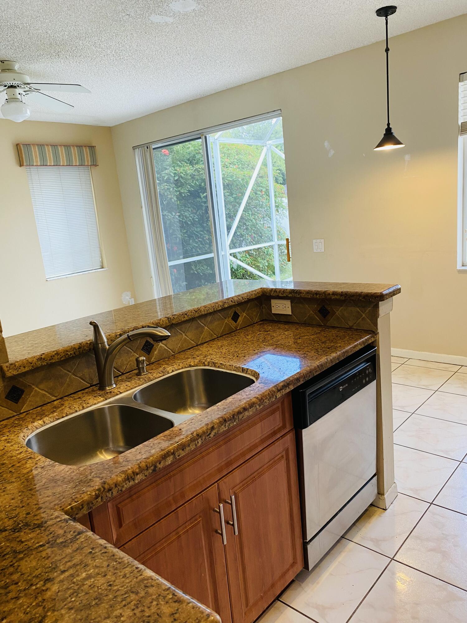 439 Talavera Road Weston, FL 33326 - Photo 4 of 17 a kitchen that has a sink and a stove