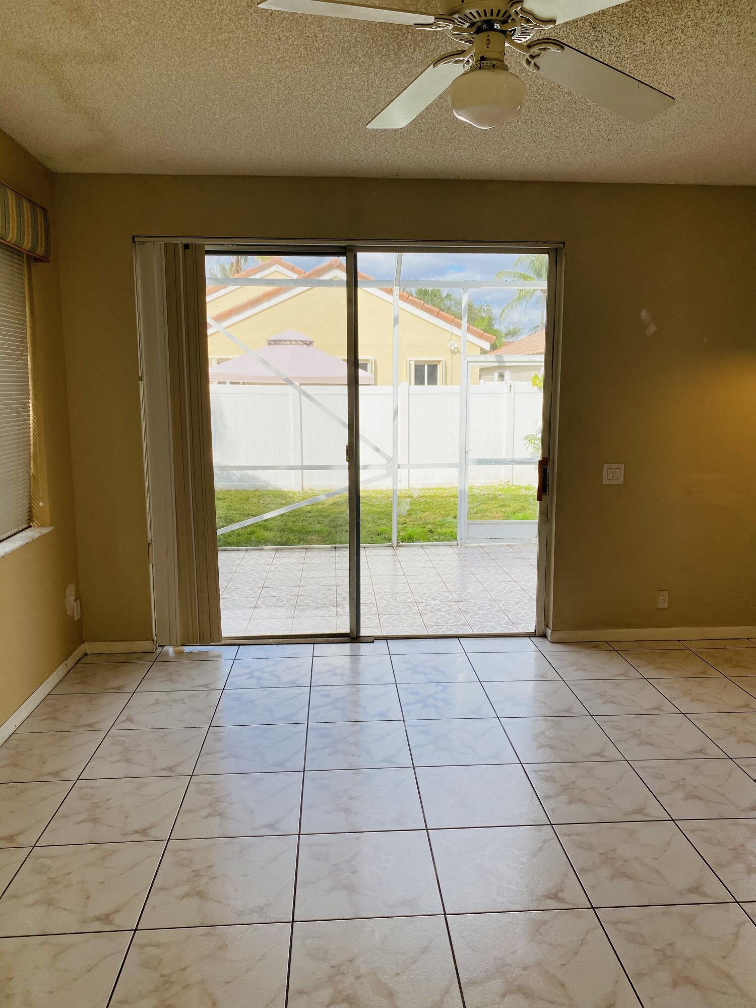 439 Talavera Road Weston, FL 33326 - Photo 5 of 17 a view of an empty room with a window