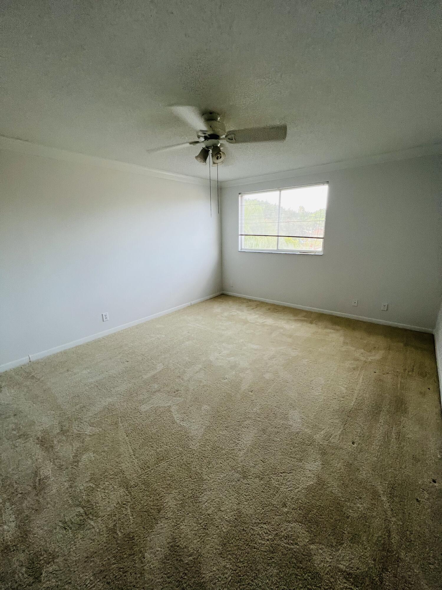 439 Talavera Road Weston, FL 33326 - Photo 8 of 17 an empty room with a ceiling fan and window
