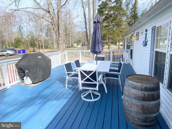 a view of a porch with furniture and a yard