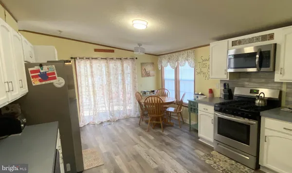 a kitchen with stainless steel appliances granite countertop a stove and a refrigerator